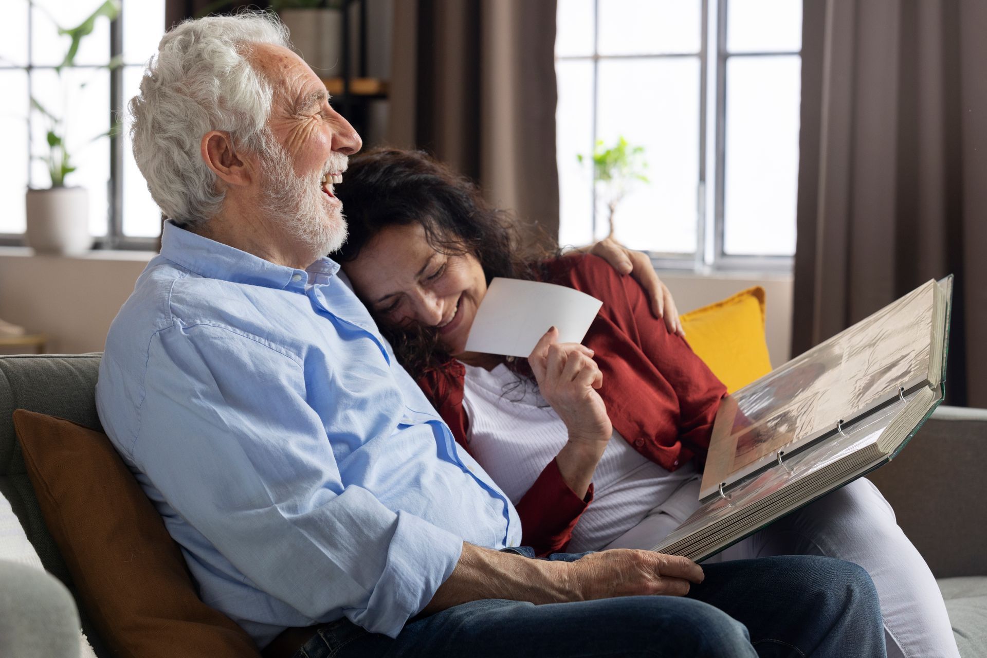 A senior grandfather sitting on a chair with his granddaughter