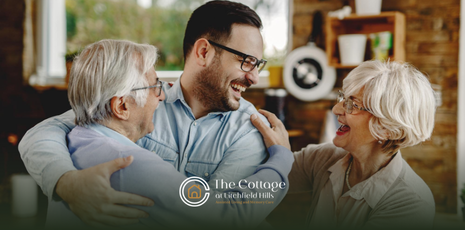A man hugging her elderly parents