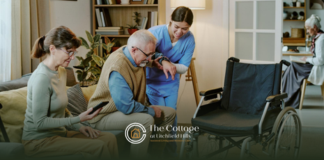 A respite care staff member helping a senior sit in his wheelchair