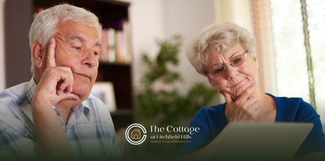 A senior couple looking at a paper, deciding