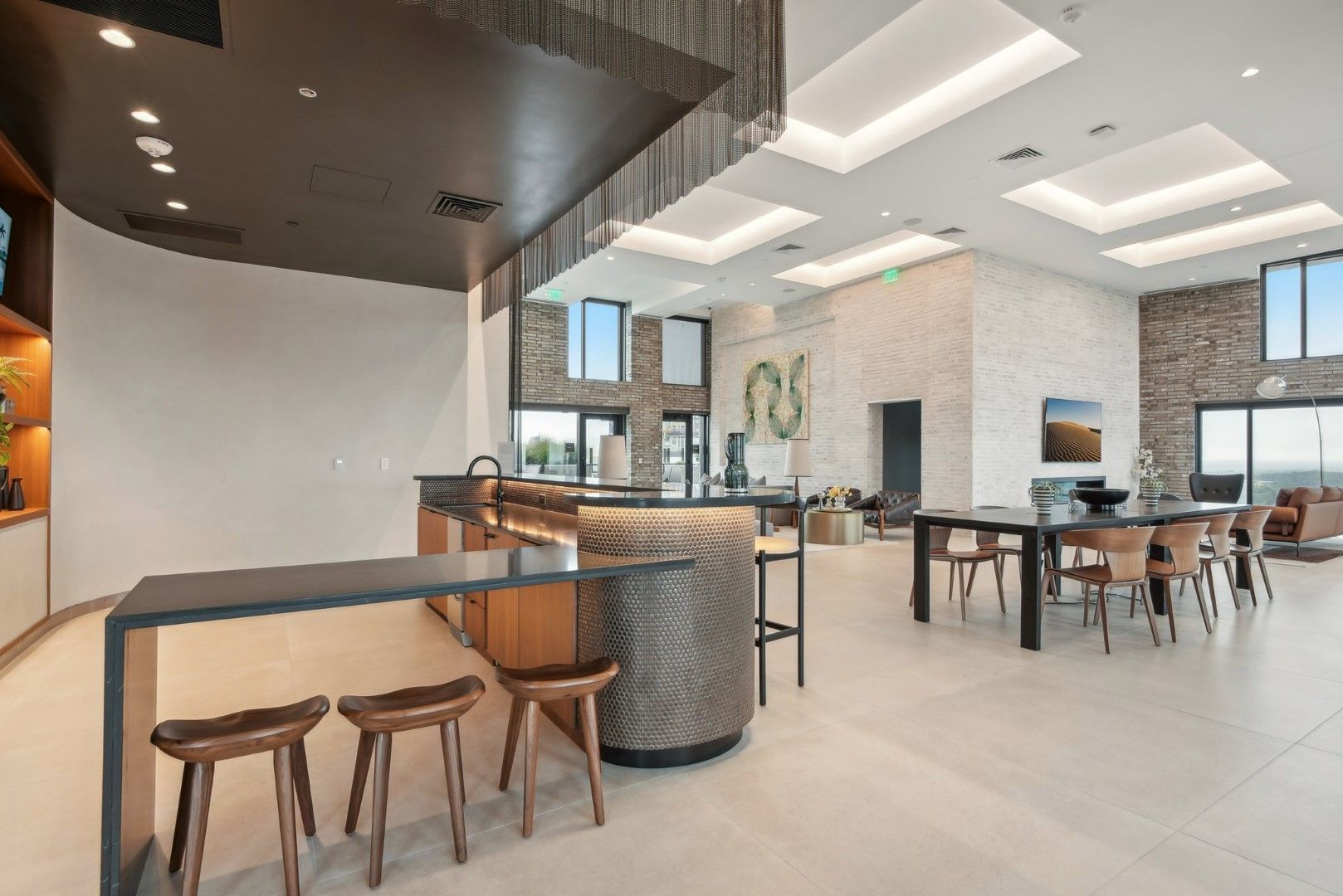 A large room with tables and chairs and a bar in the middle.