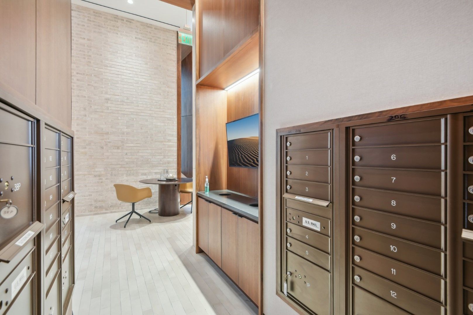 A hallway filled with mailboxes and a desk in a building.