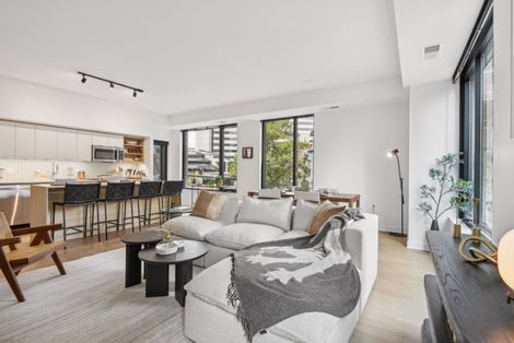 A living room with a couch , table , chairs and a kitchen at Solaire 7607 Old Georgetown
