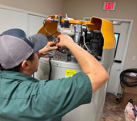 Professional plumber repairing a home water heater in Georgetown, TX.