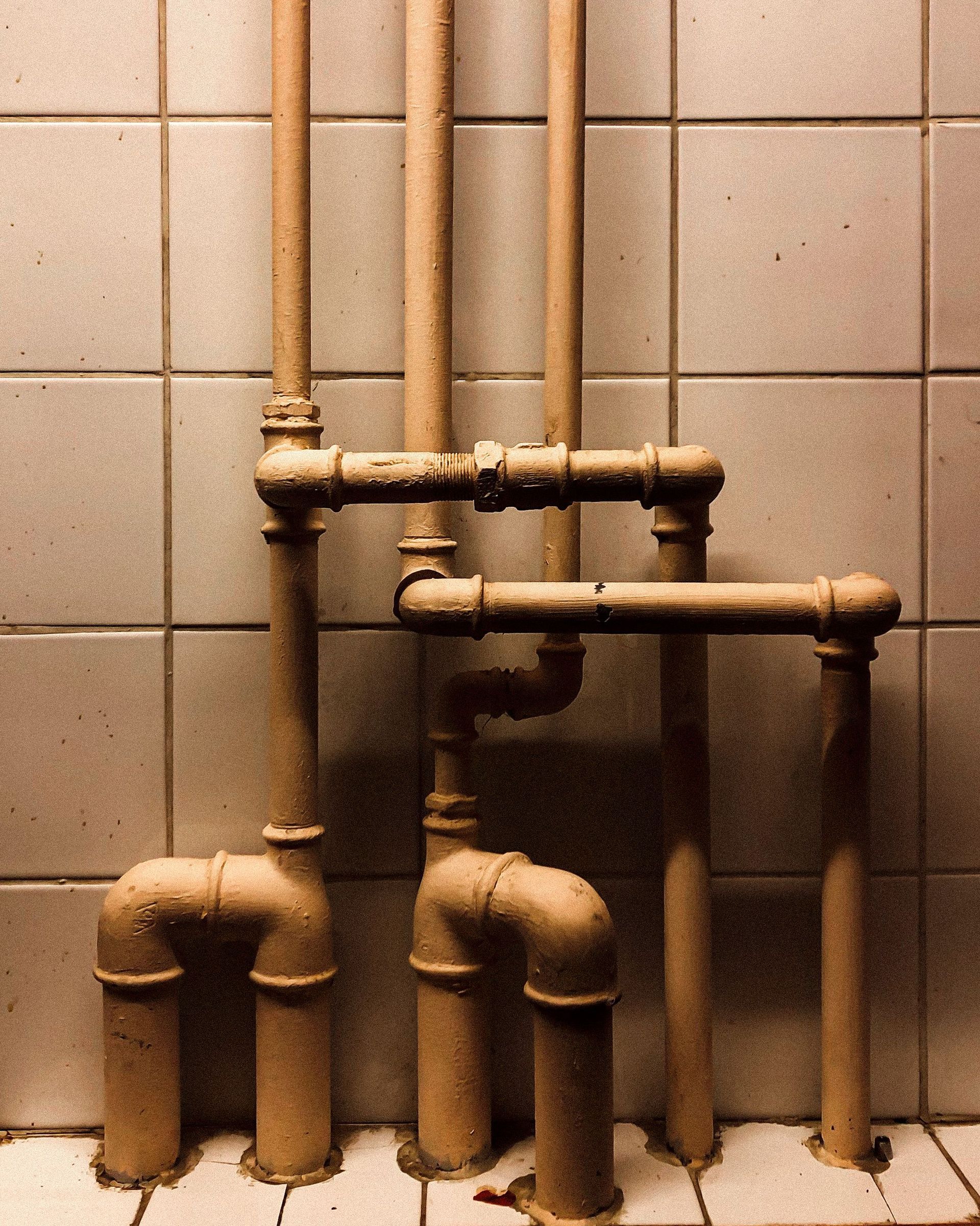 Corroded bathroom pipes needing house repipe to prevent leaks and water damage.