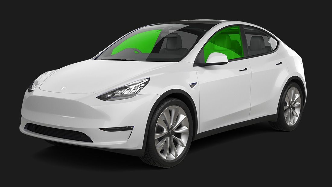 A white tesla model y with a green window on a black background.