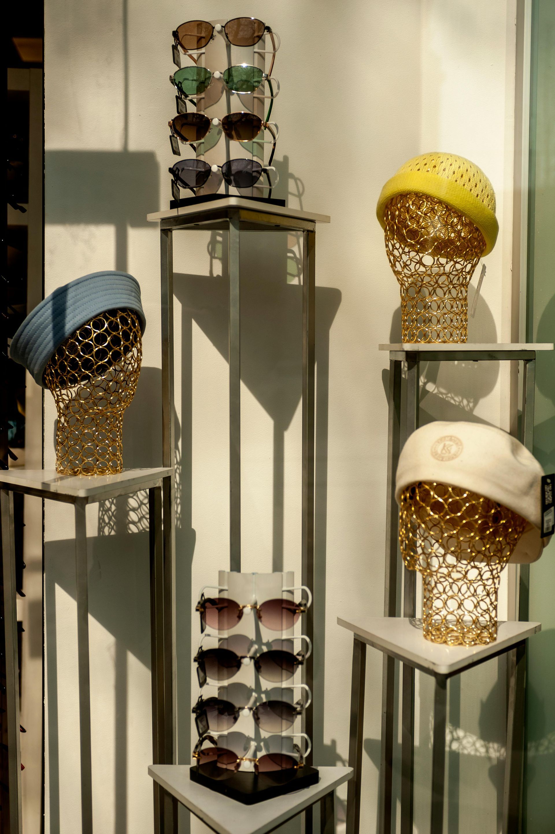 Retail items on tall metal displays in a gallery setting.