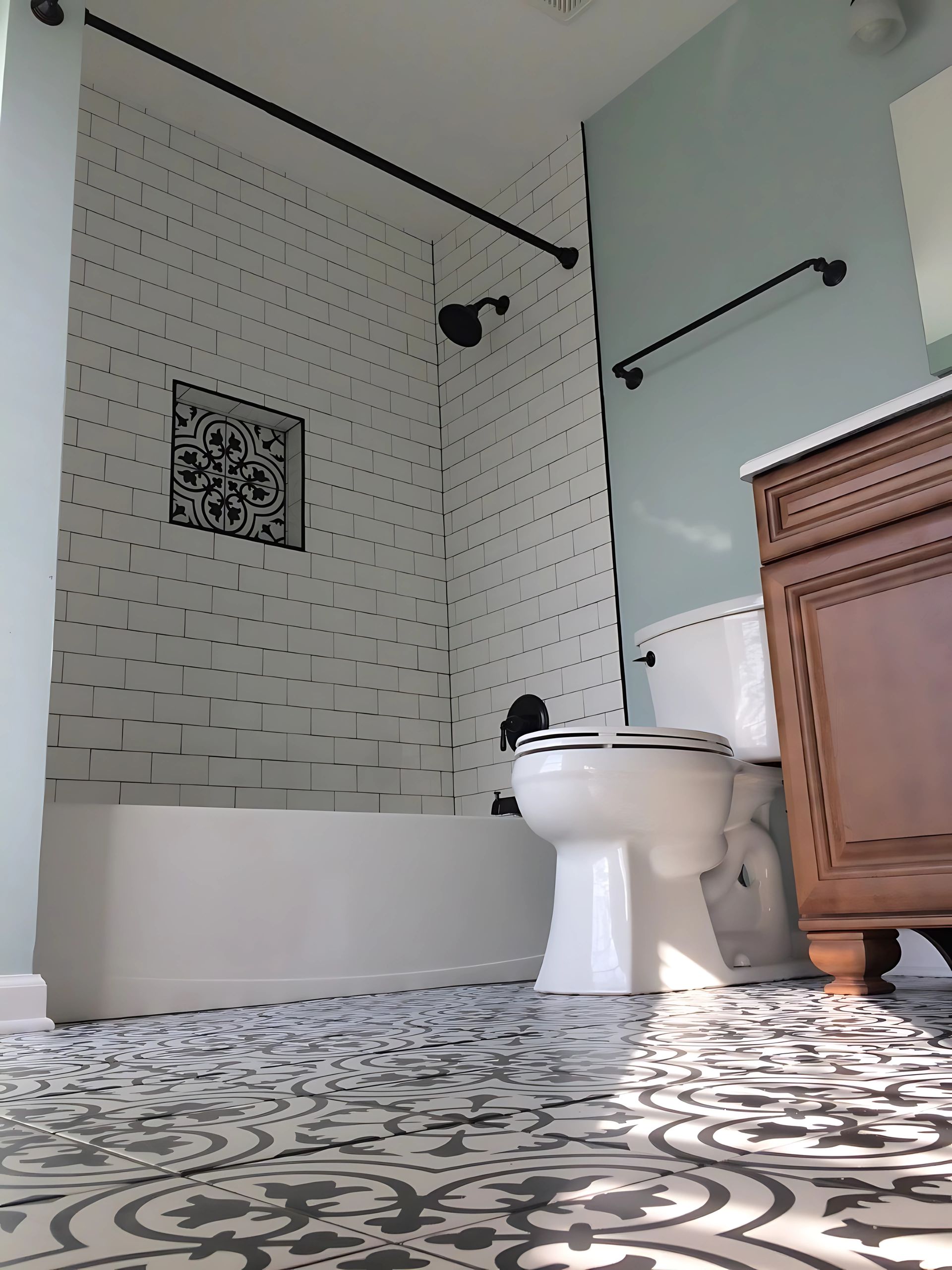 A bathroom with a toilet , sink , bathtub and shower.