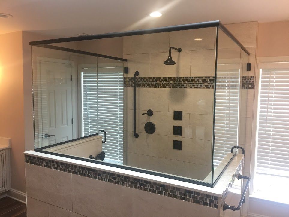 A bathroom with a walk in shower and a bathtub.
