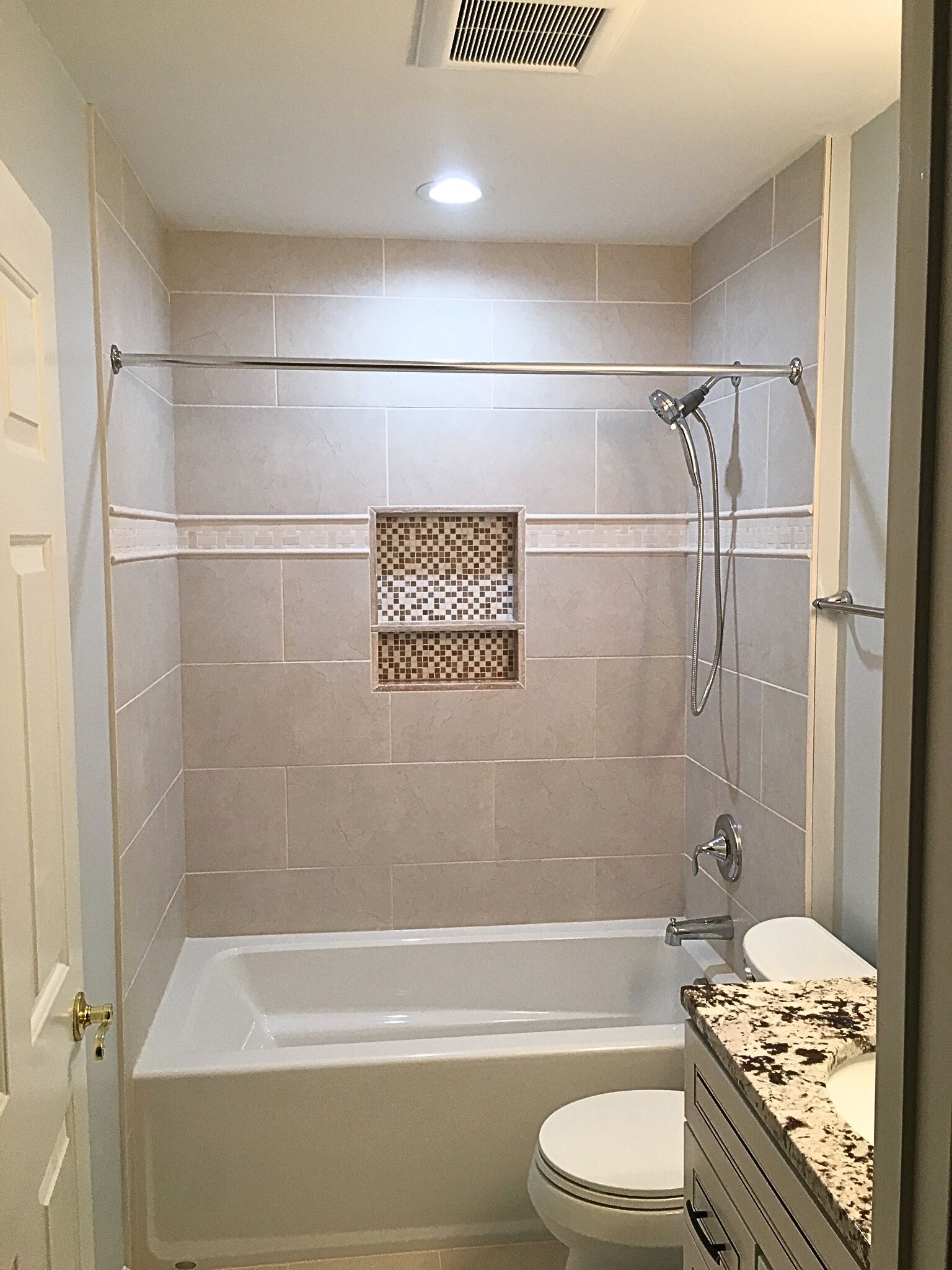 A bathroom with a tub, toilet, sink and shower.