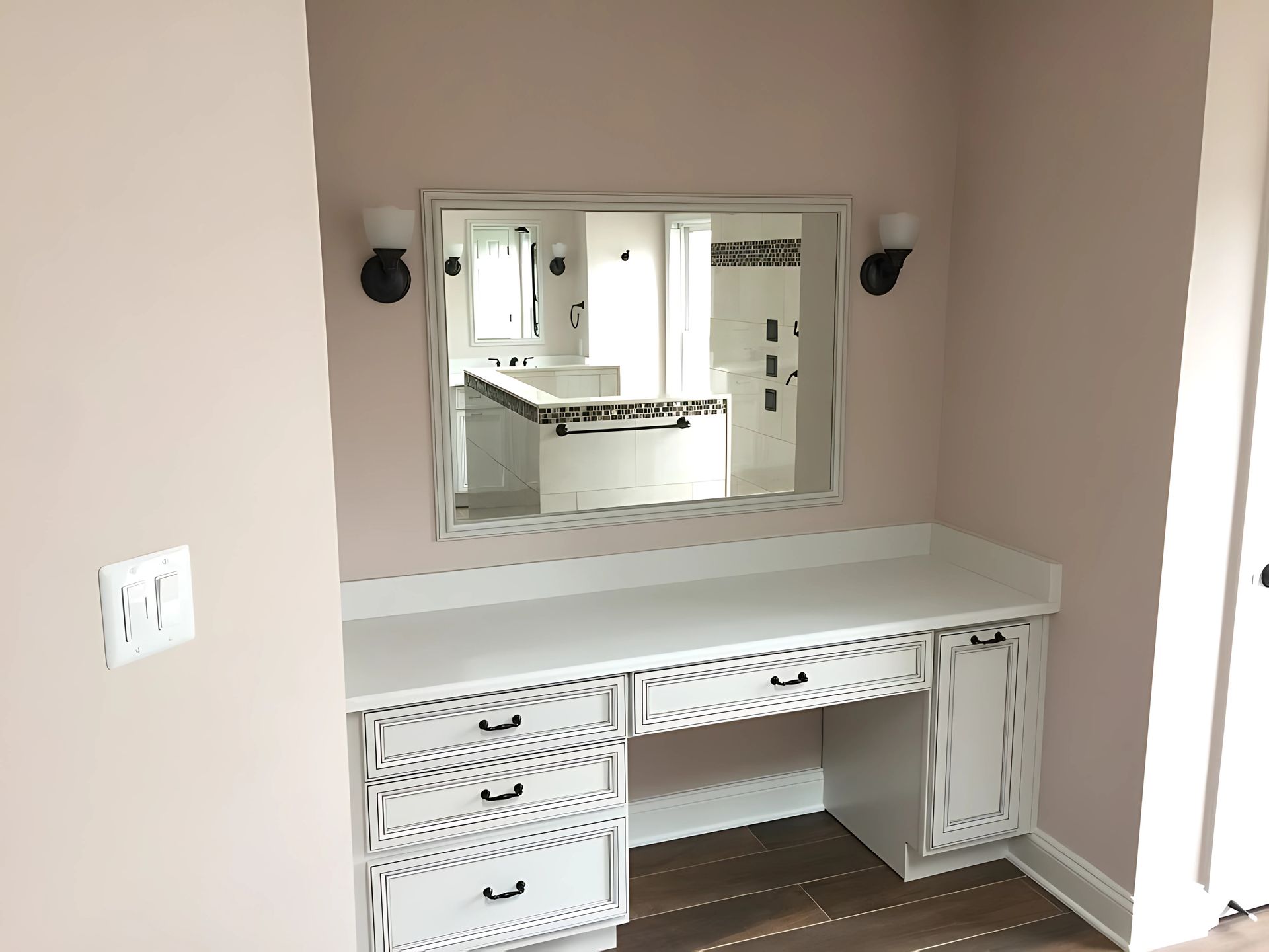 A vanity with drawers and a mirror in a room