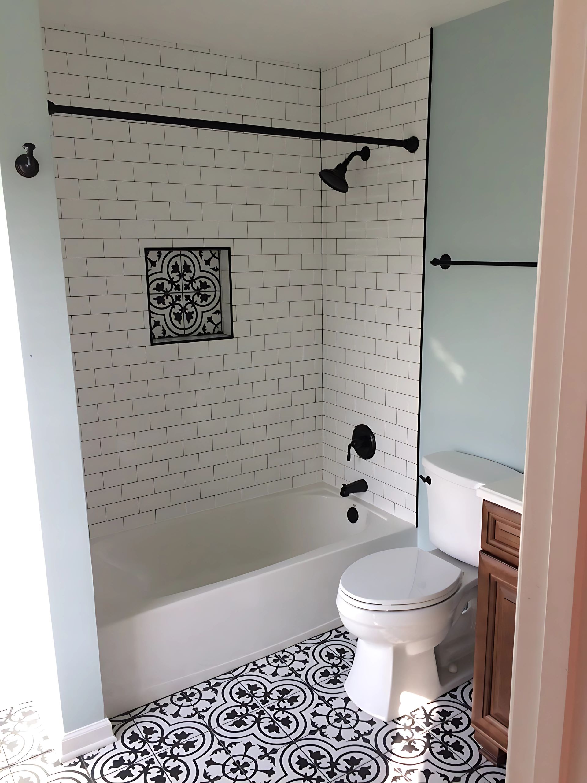 Bathroom with white tiles, a toilet, bathtub and shower.