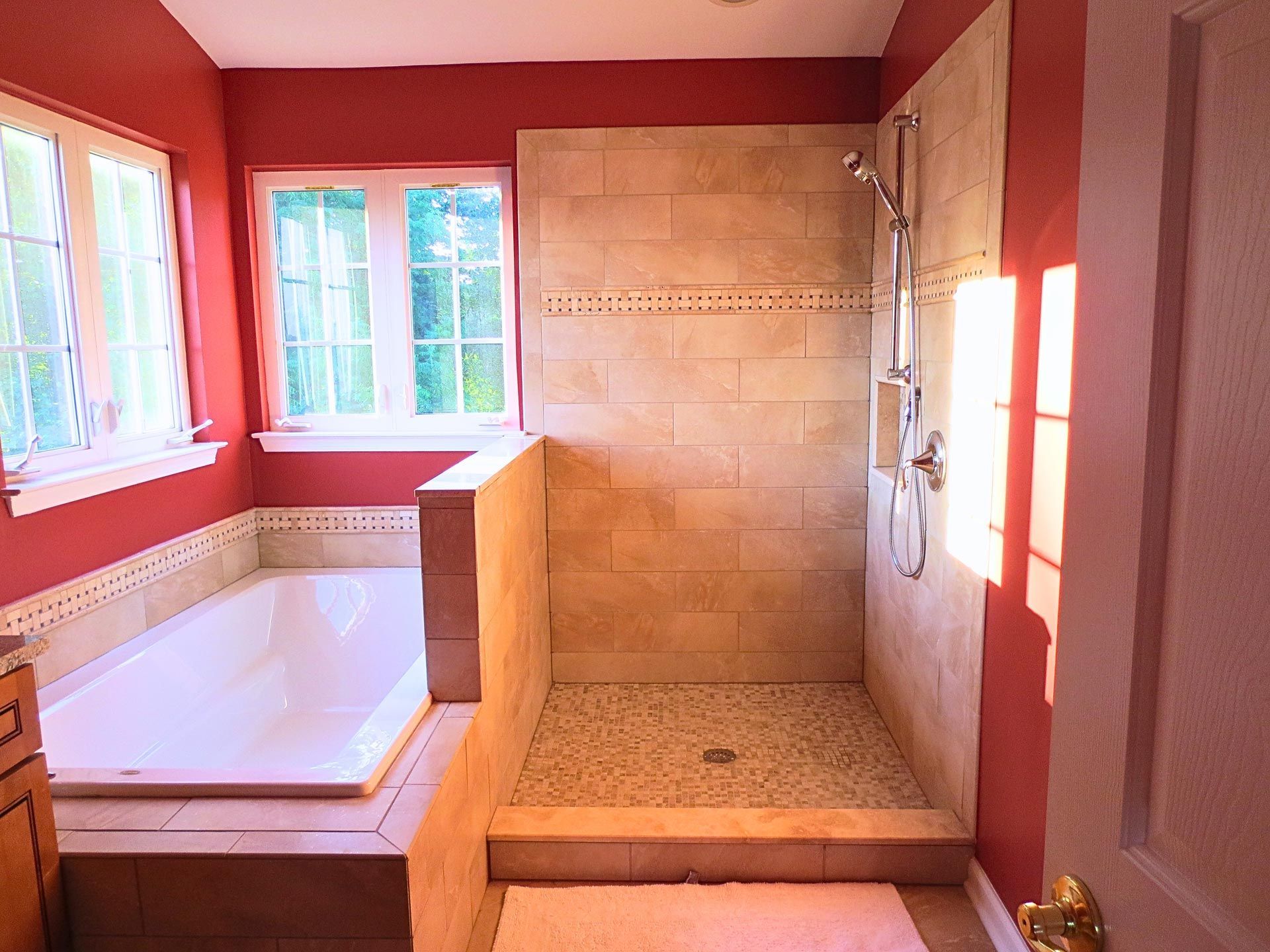 A bathroom with a tub and a walk in shower