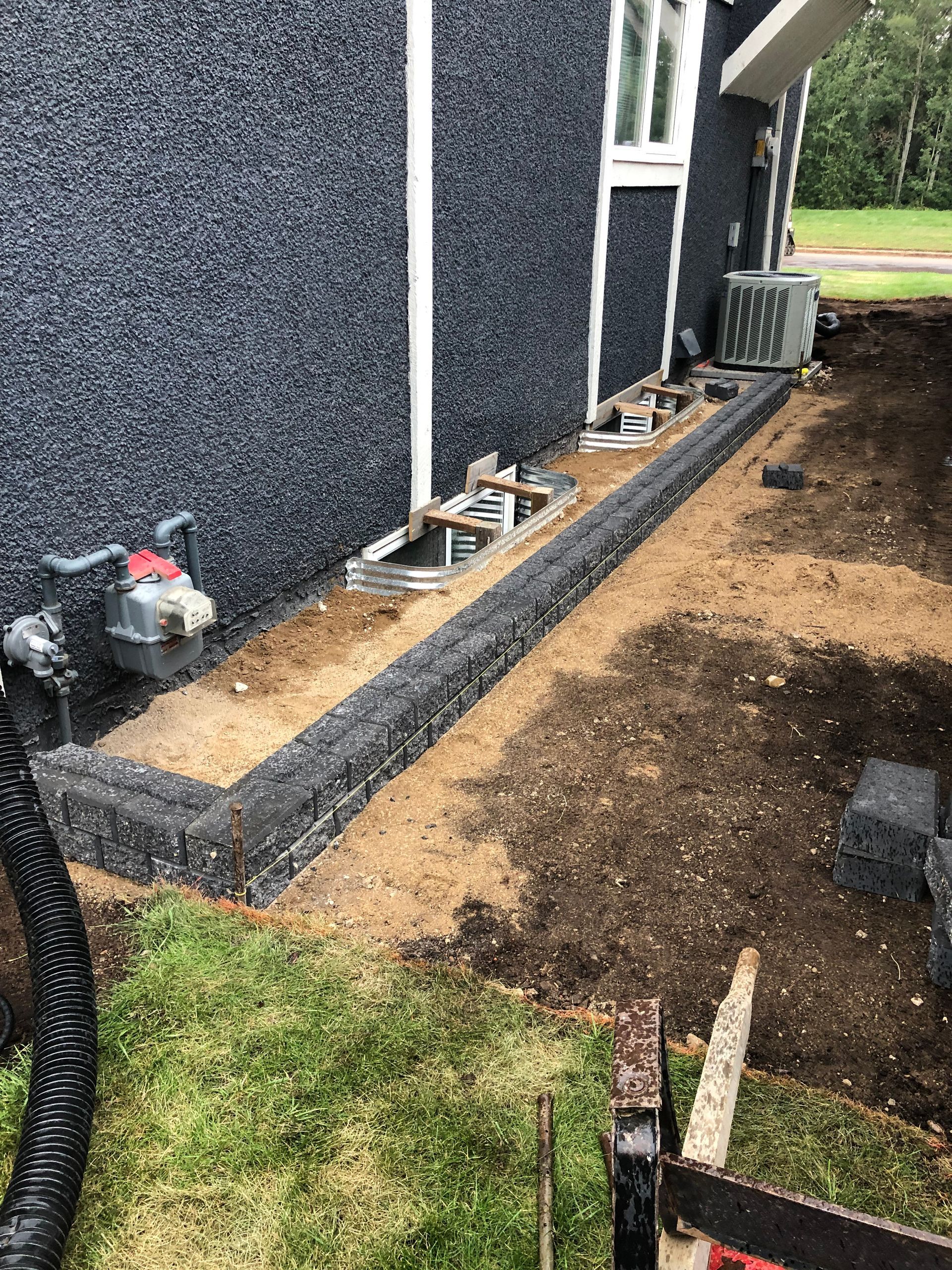 A sidewalk is being built in front of a house.