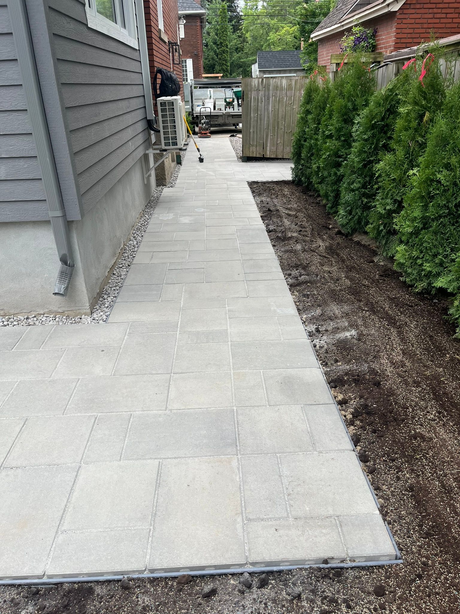 A sidewalk is being built in front of a house.