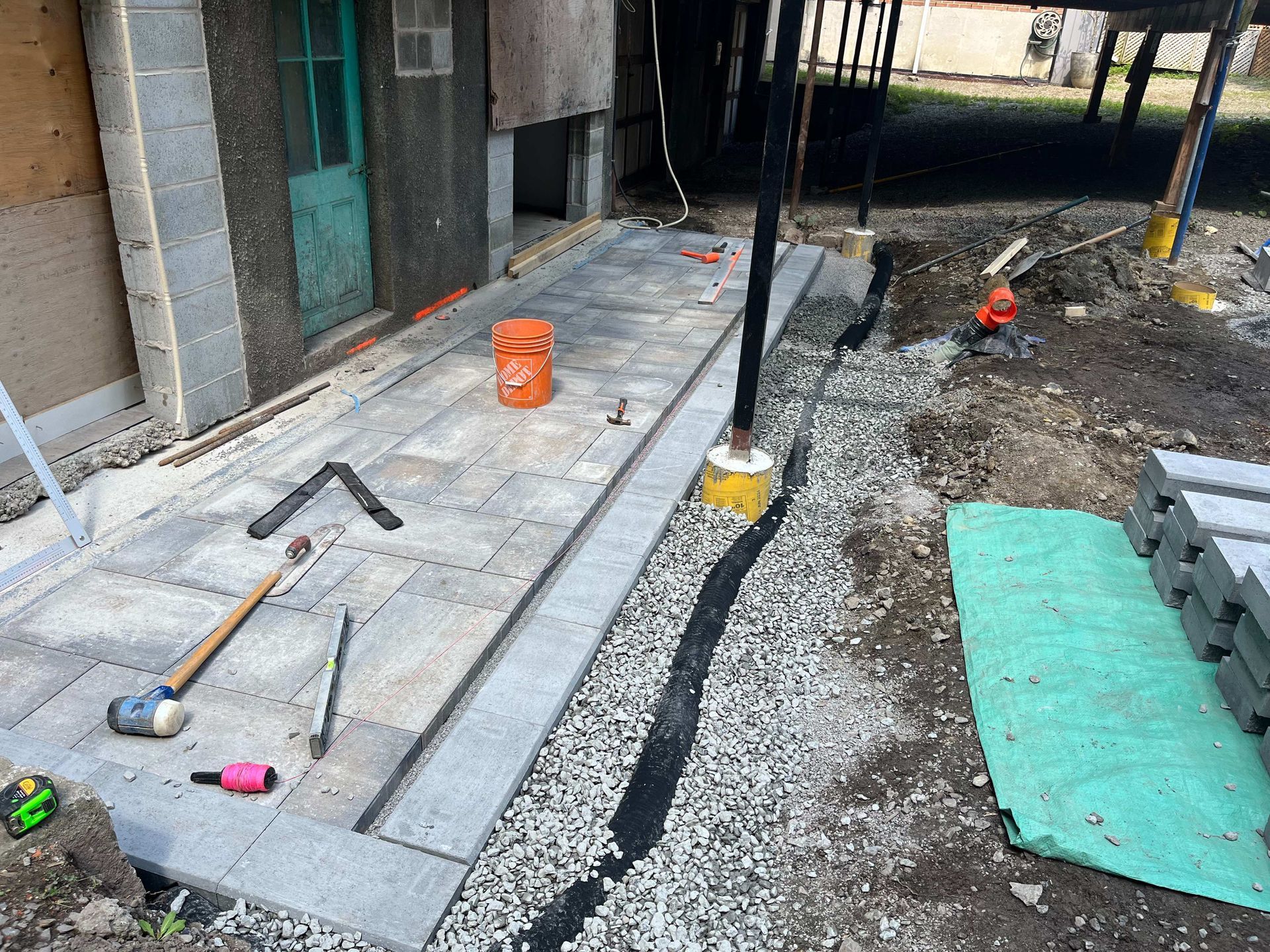 A concrete walkway is being built in front of a house.