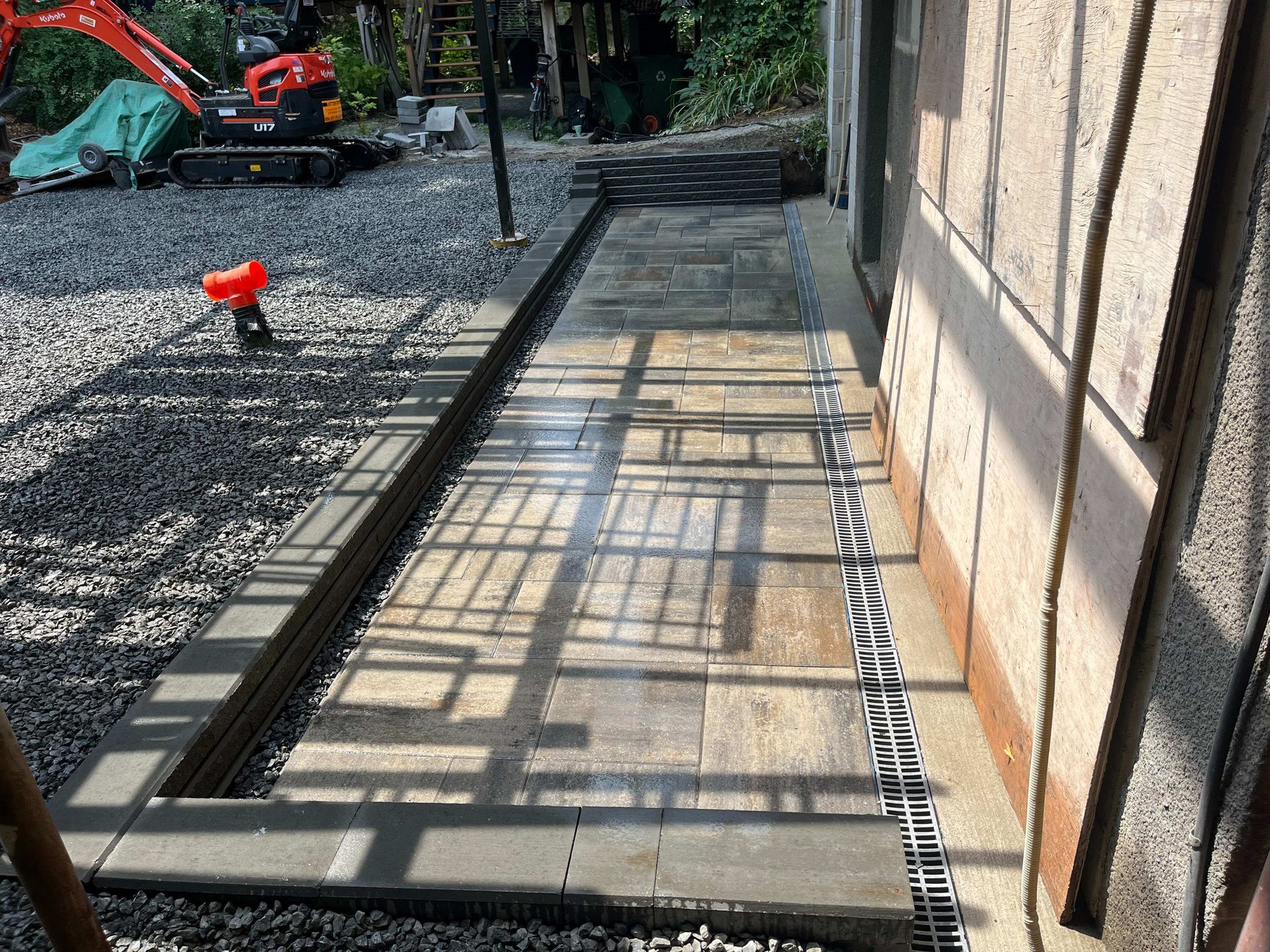 A walkway is being built next to a building.
