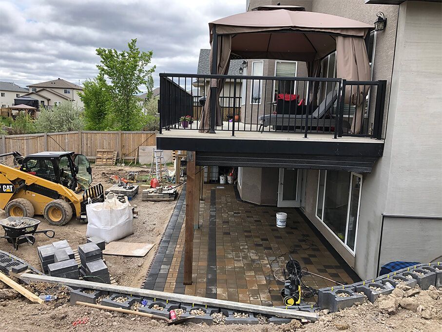 A large house with a deck and patio under construction.