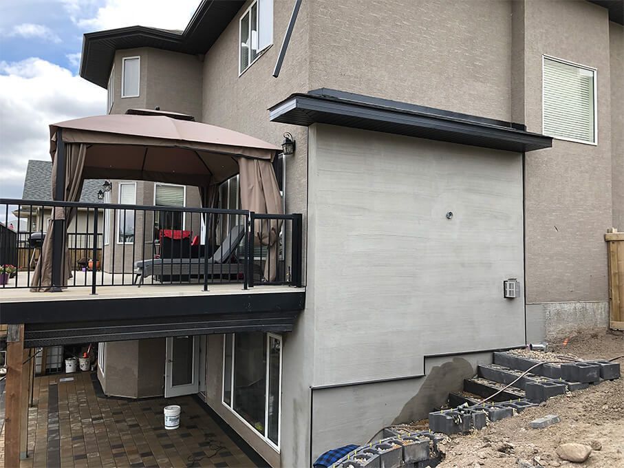 The back of a house with a large deck and gazebo.