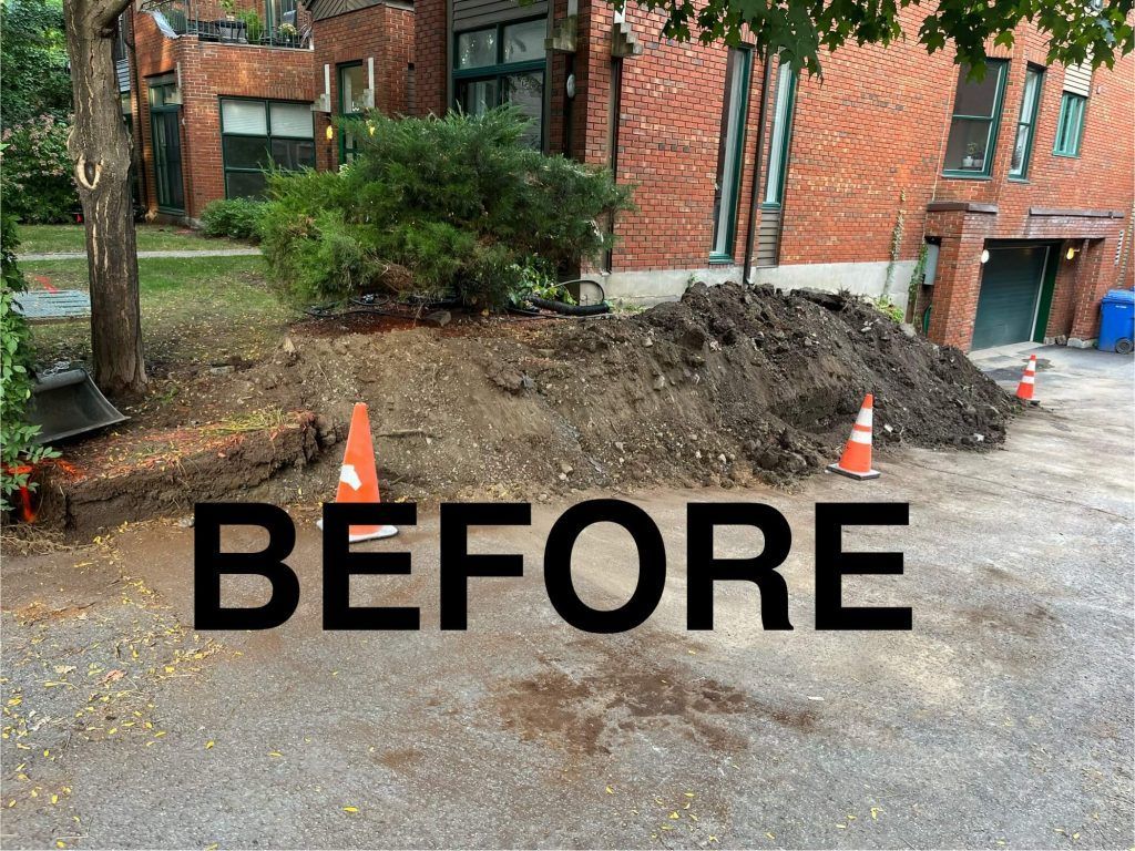 A pile of dirt in front of a brick building with the words before written on it