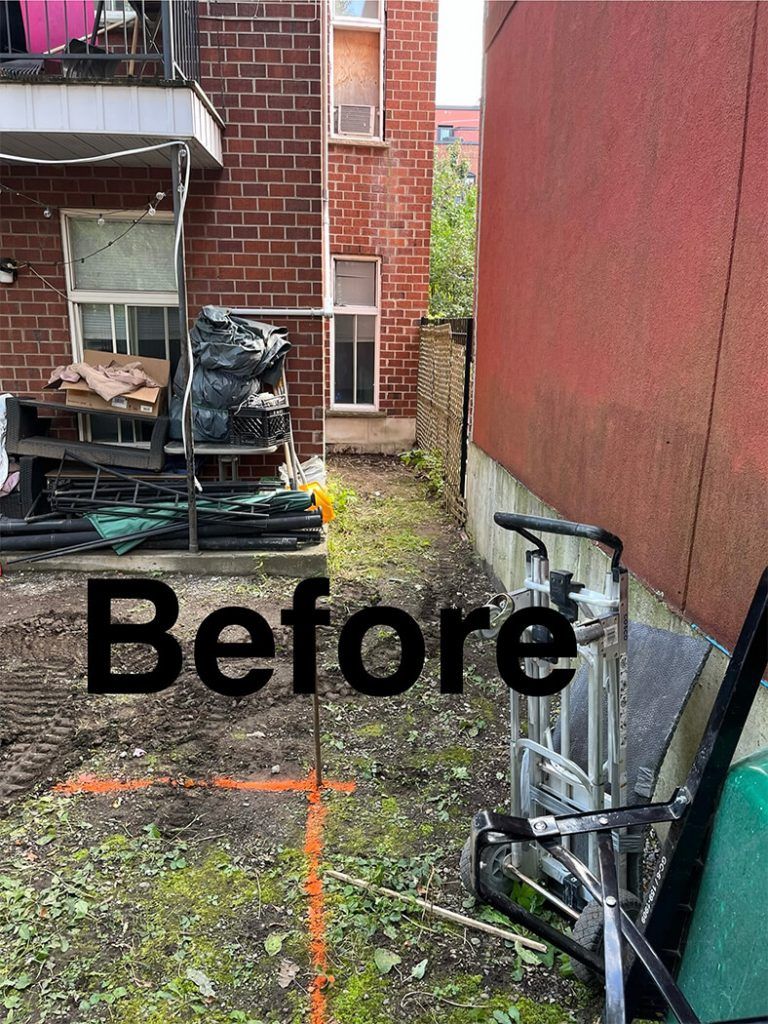 A before picture of a brick building with a bicycle parked in front of it.