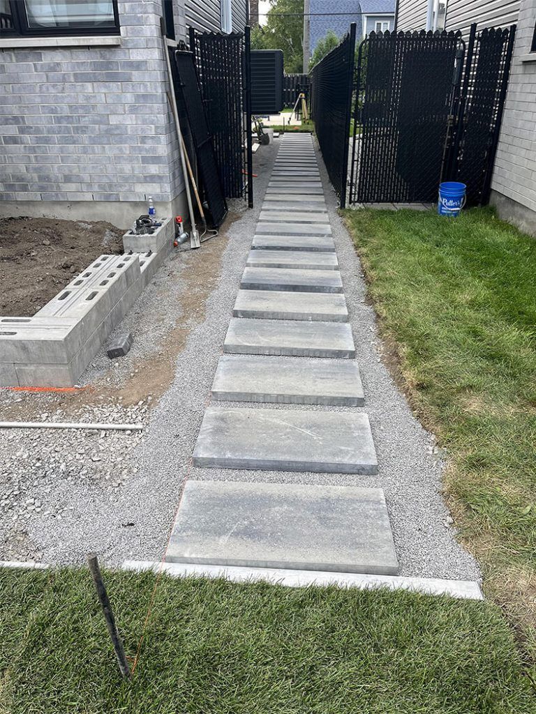 A sidewalk is being built in front of a house.