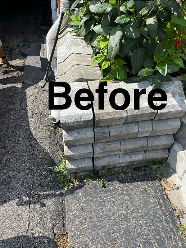 A stack of concrete blocks sitting on top of each other on a sidewalk.