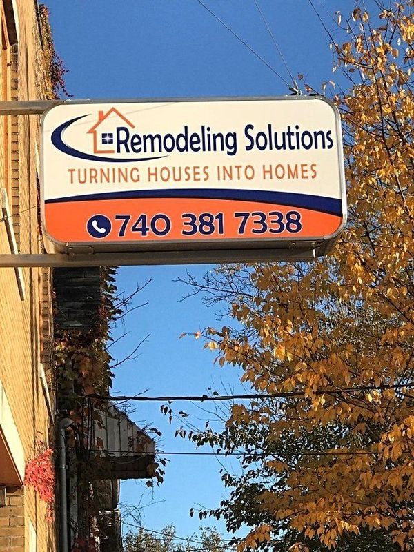 Storefront sign for Remodeling Solutions, turning houses into homes, with phone number 740-381-7338
