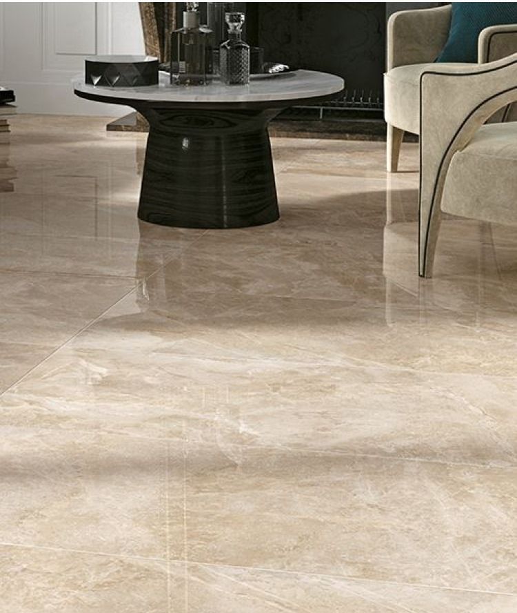 Polished beige marble tile flooring in a living room, with a coffee table and armchair visible.