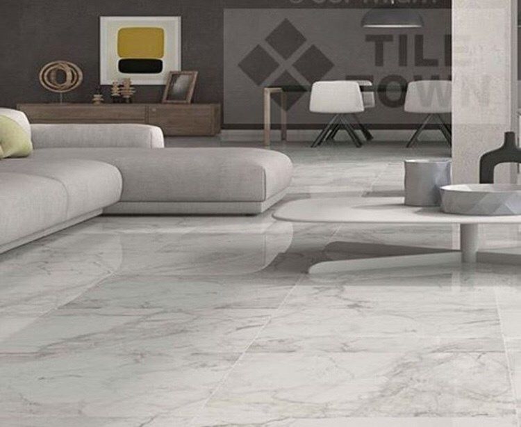 Living room with white marble-like flooring, a gray sofa, and modern decor.