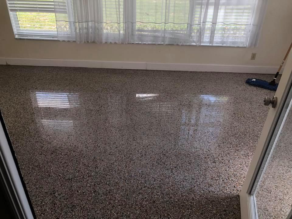 Polished concrete floor in a room with a window and a partly visible door.