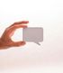 A hand is holding a small white speech bubble.