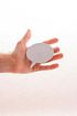 A person is holding a white speech bubble in their hand.