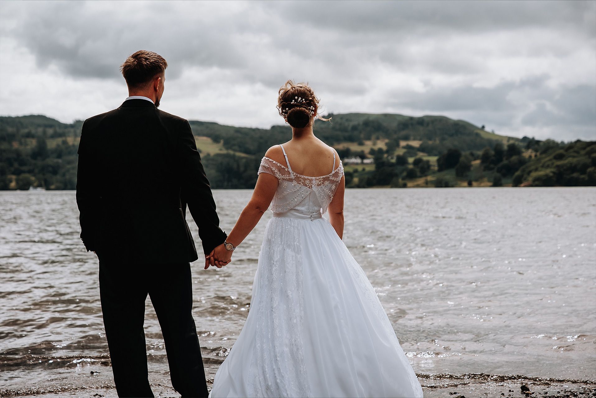 Newly married couple enjoying portraits overlooking Windermere