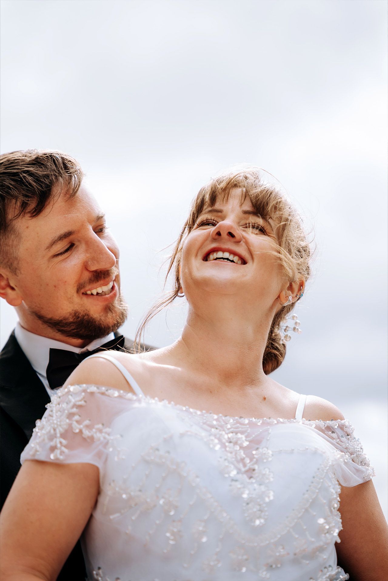 Newly married couple enjoying portraits overlooking Windermere