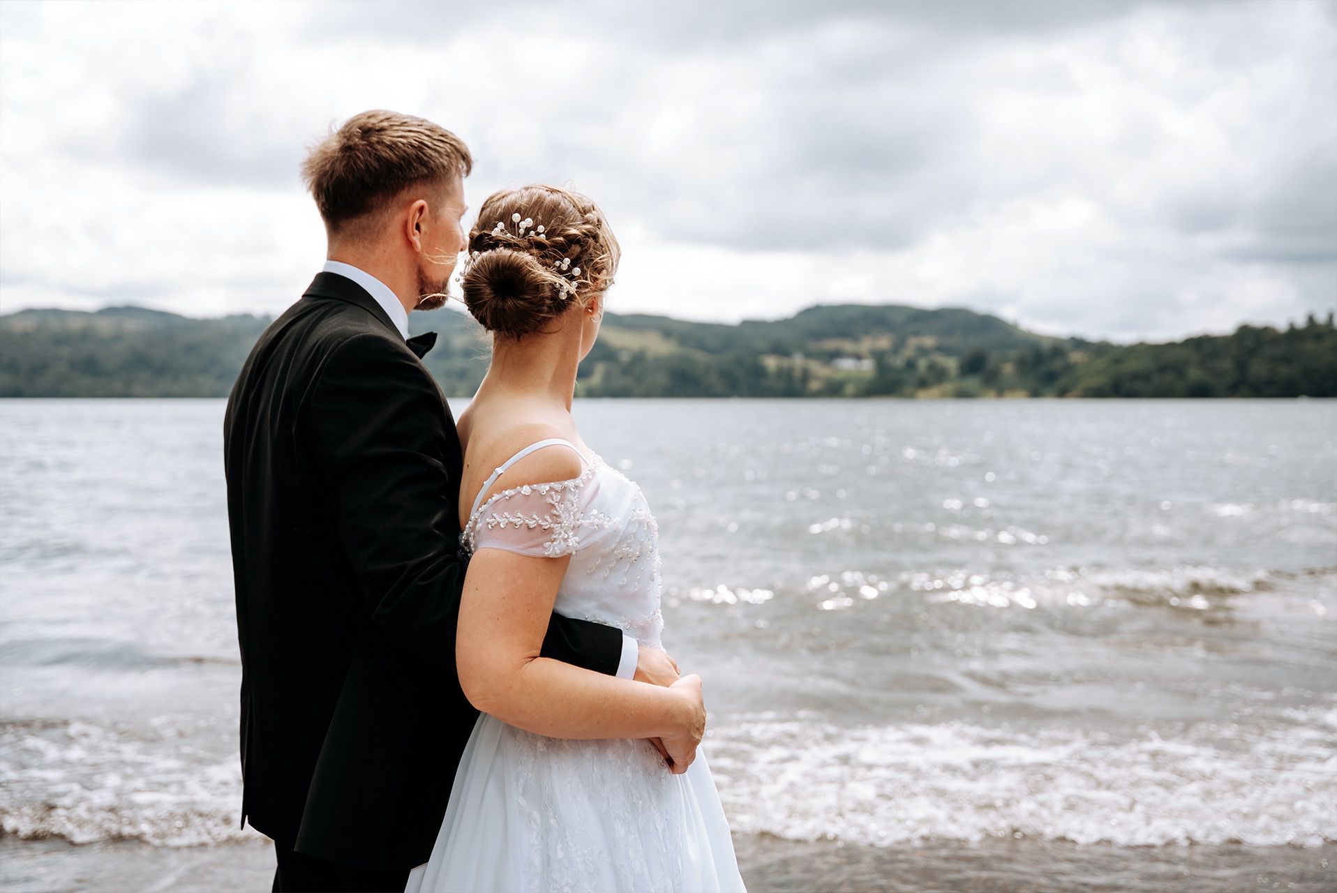 Newly married couple enjoying portraits overlooking Windermere
