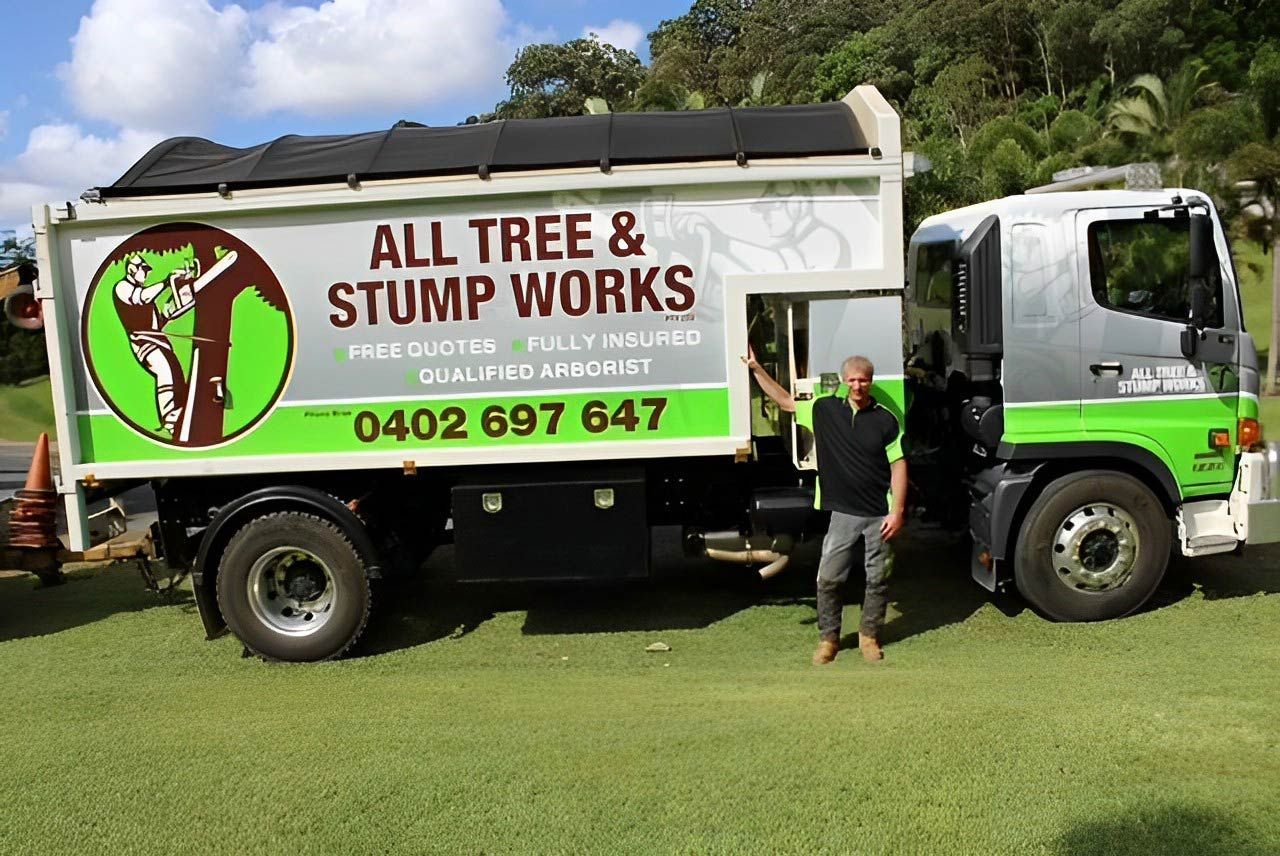 Worker Standing Beside an All Tree & Stump Works Truck — All Tree and Stump Works in Gold Coast QLD