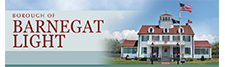 Banner for the Borough of Barnegat Light featuring its historic building under a blue sky with an American flag.