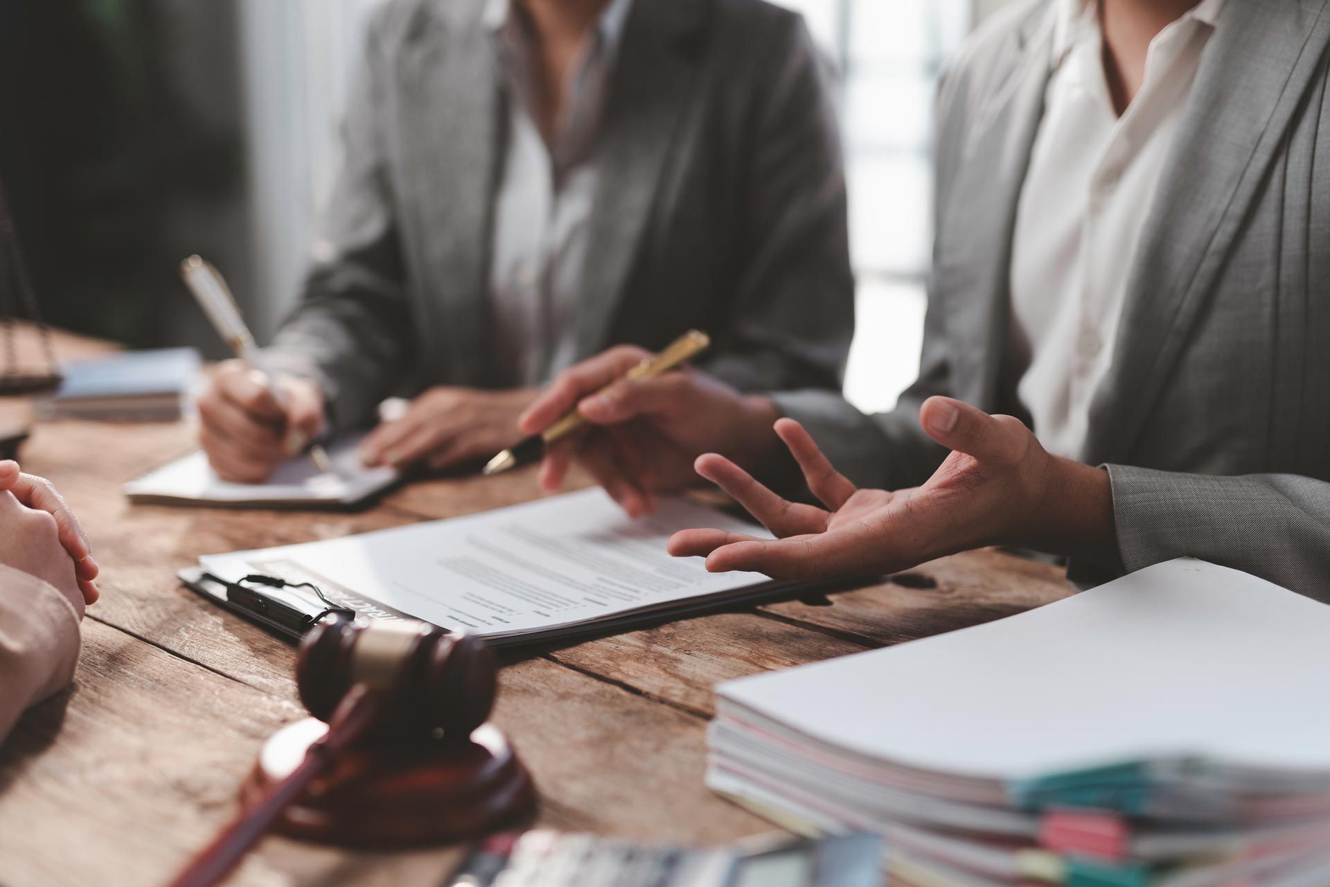 General civil law lawyer discussing a contract with clients in a professional office setting.