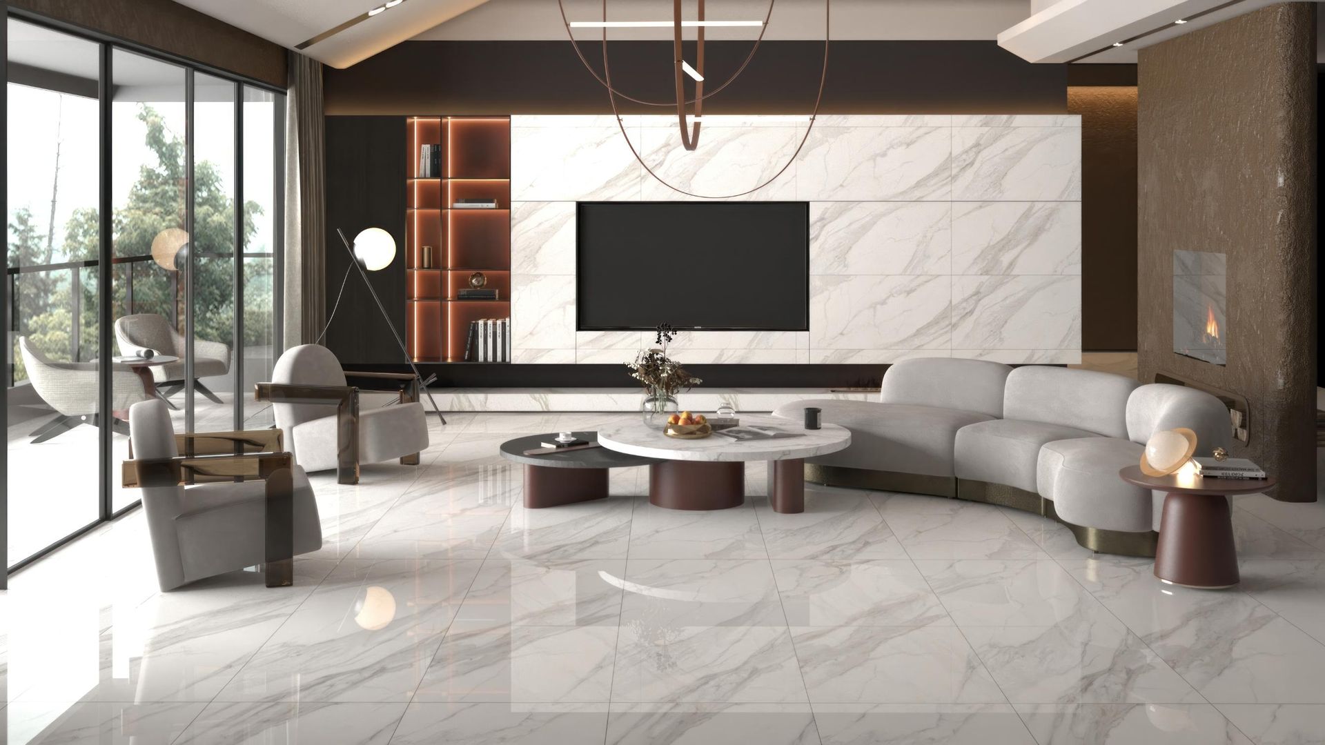 A modern living room with gray curved sofas, a marble-topped coffee table, and a large wall-mounted television.