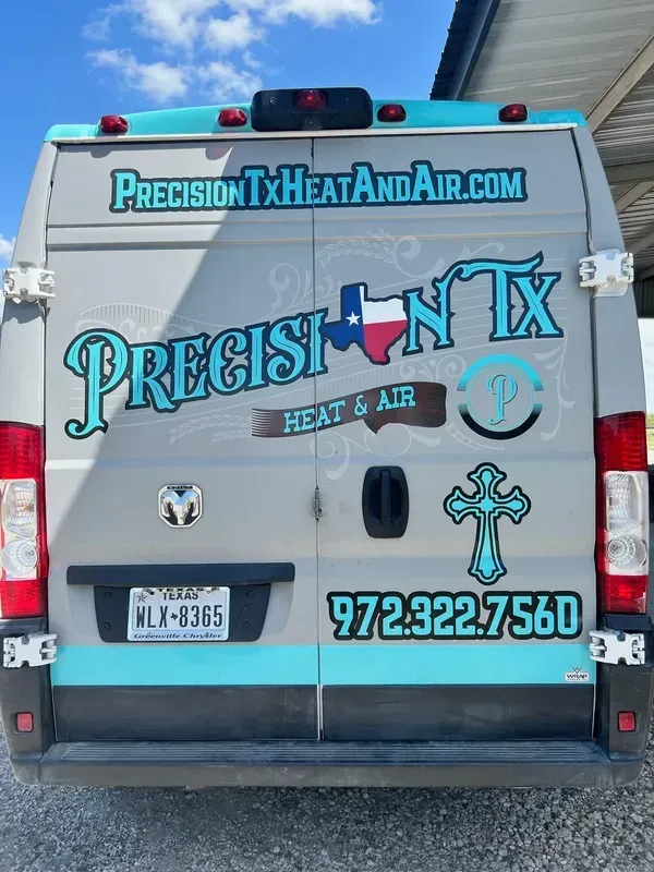Blue Precision TX Heat & Air service van with company logos, website, and phone number parked outdoors