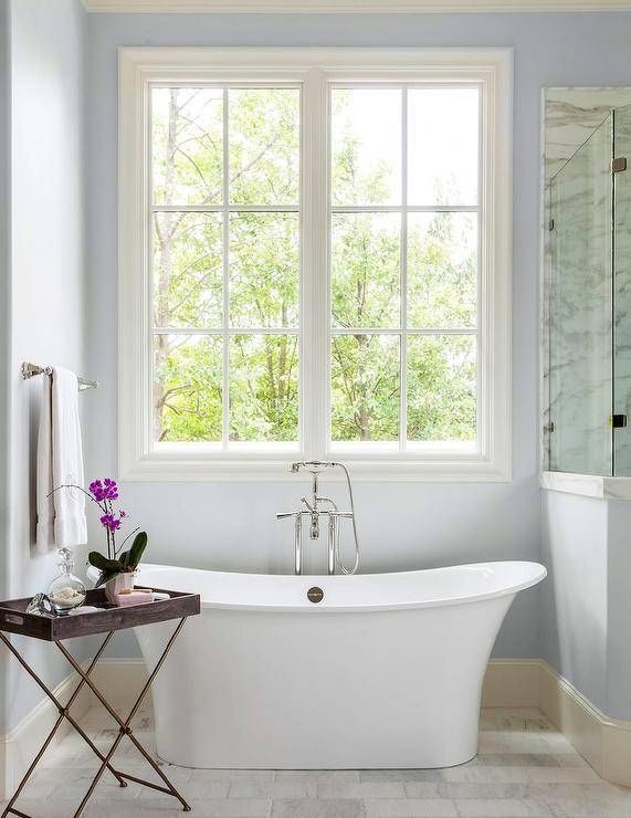A bathroom with a tub and a window.