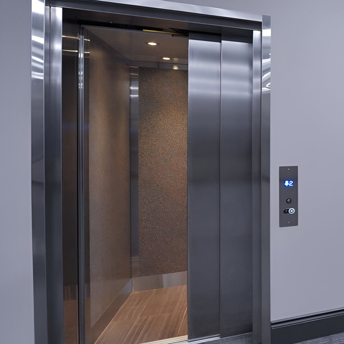 Ascenseur ouvert avec portes en acier inoxydable et panneau de commande éclairé dans un couloir