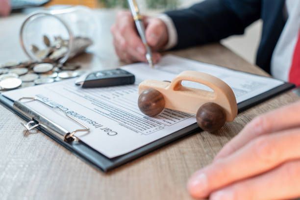 A car insurance agent customizing an auto insurance coverage plan for a client.