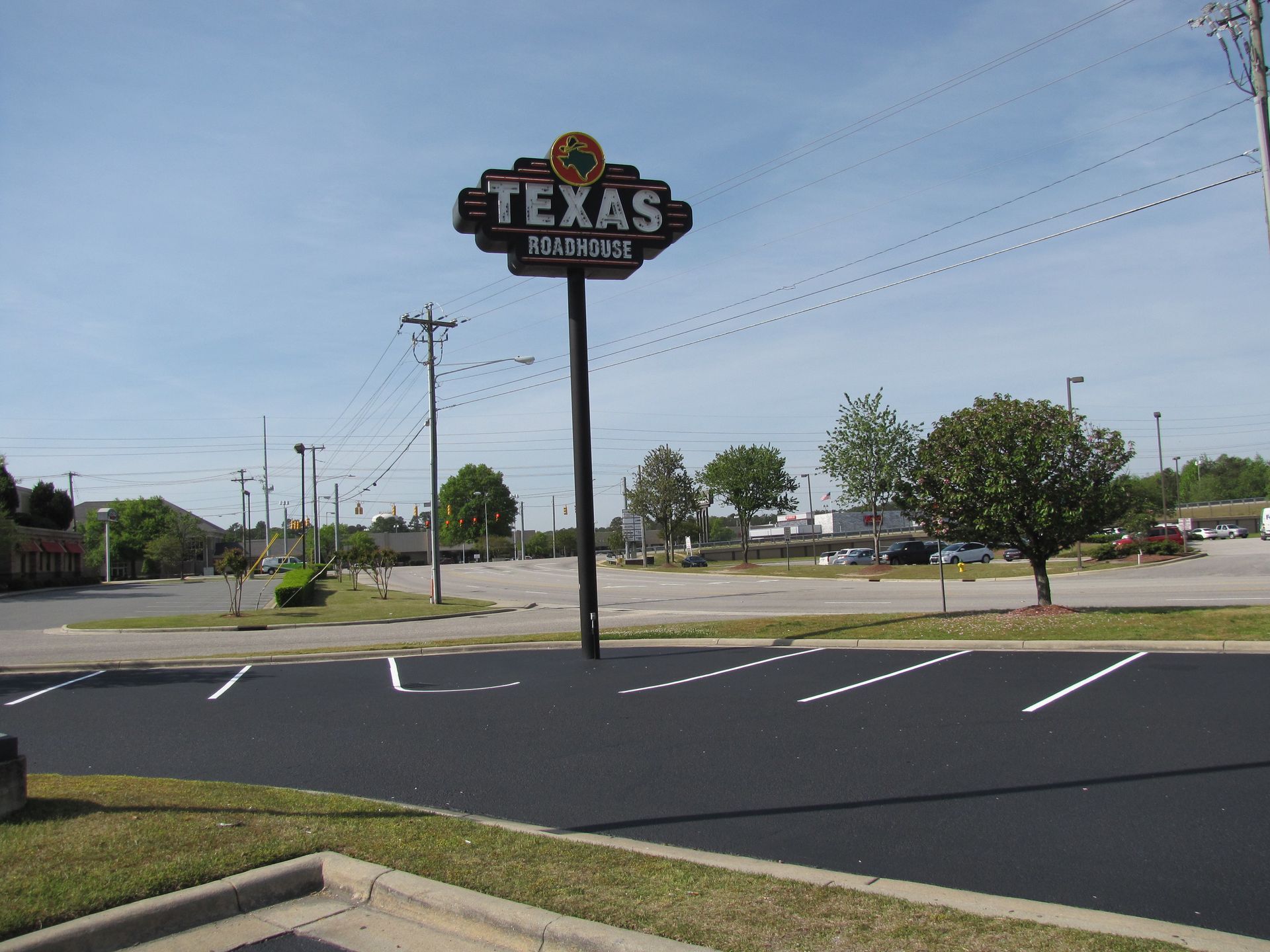 Texas sign over an empty parking lot on a sunny day