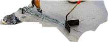 A worker uses a handheld tool to apply black sealant into a crack on a grey pavement surface.
