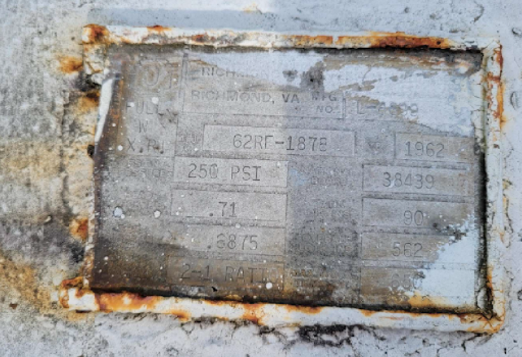 Metal plate with faded text and rust, from Richmond, VA. Includes: 62RC-1876, 1982, 250 PSI, and a serial number.
