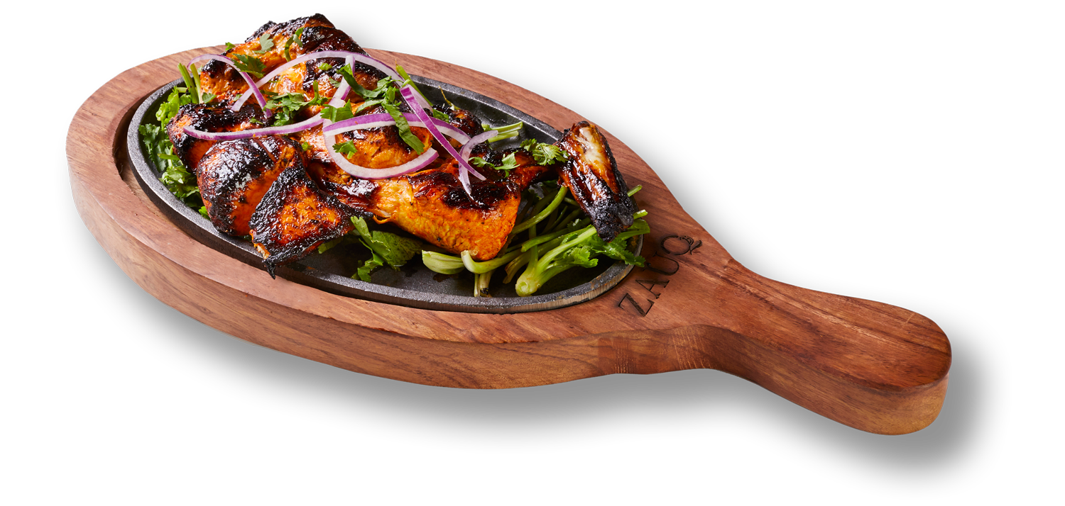 A wooden tray filled with meat and vegetables on a white background.