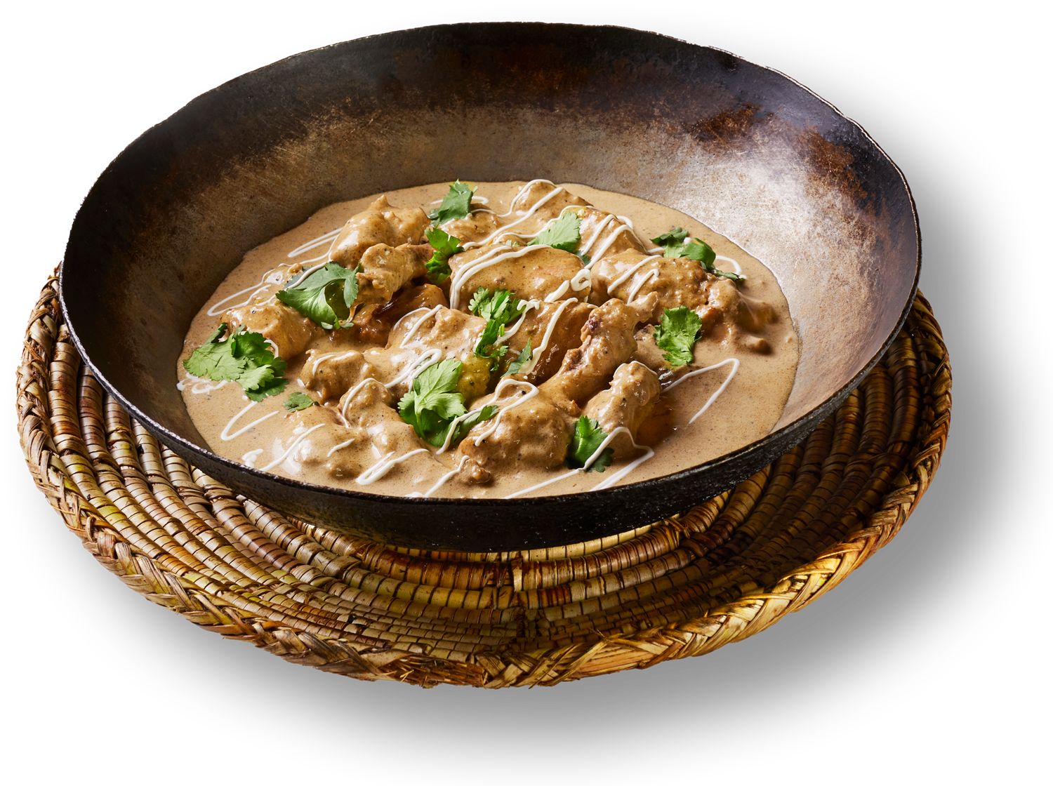 A pan filled with a creamy sauce and meat