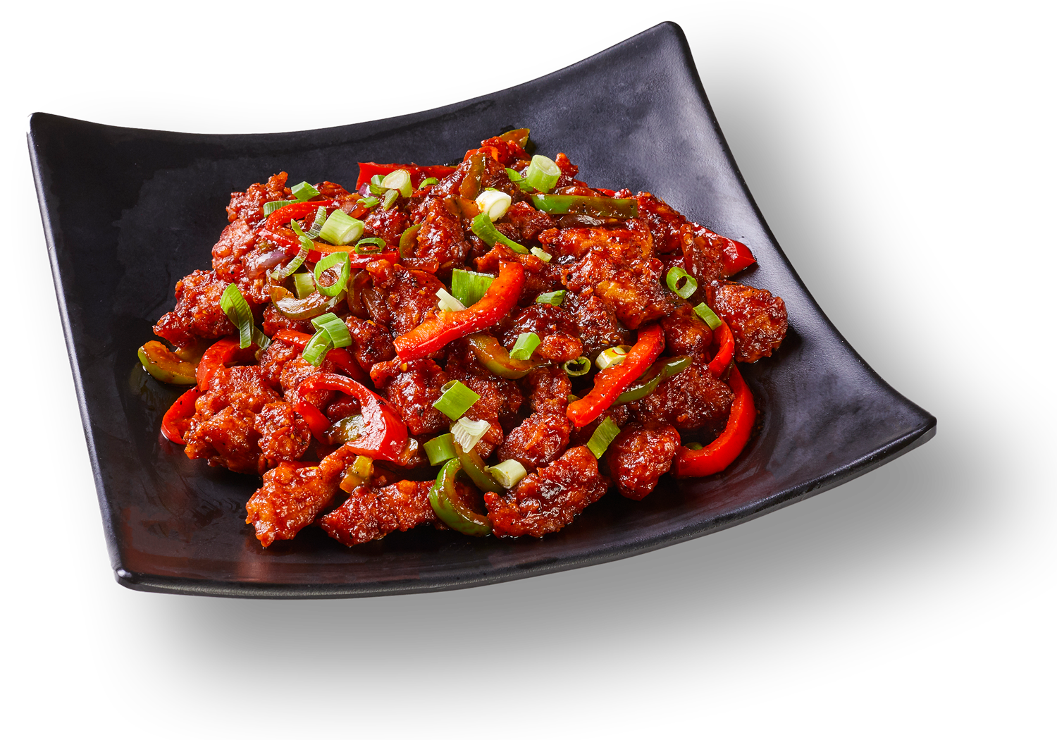 A black plate topped with meat and vegetables on a white background